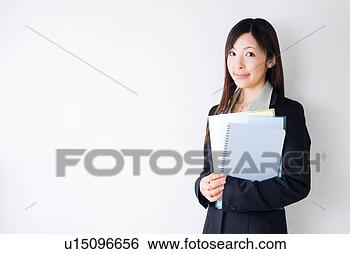 Stock Photo - a mid adult woman 
holding documents. 
fotosearch - search 
stock photos, 
pictures, images, 
and photo clipart
