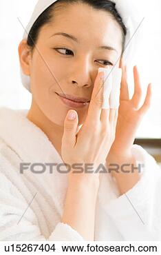 Stock Photo - a mid adult woman 
applying moisturizer. 
fotosearch - search 
stock photos, 
pictures, images, 
and photo clipart