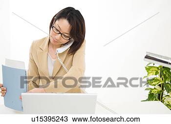 Stock Photo - a mid adult woman 
working. fotosearch 
- search stock 
photos, pictures, 
images, and photo 
clipart