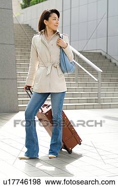 Stock Photo - a mid adult woman 
pulling suitcase. 
fotosearch - search 
stock photos, 
pictures, images, 
and photo clipart