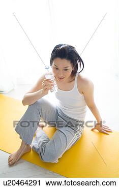 Stock Photography - a mid adult woman 
holding a bottle 
of water. fotosearch 
- search stock 
photos, pictures, 
images, and photo 
clipart