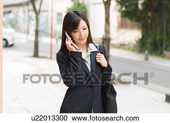 Stock Photography - a mid adult woman 
using mobile phone. 
fotosearch - search 
stock photos, 
pictures, images, 
and photo clipart