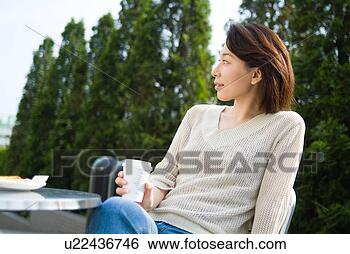 Stock Photo - a mid adult woman 
sitting in outdoor 
chair. fotosearch 
- search stock 
photos, pictures, 
images, and photo 
clipart