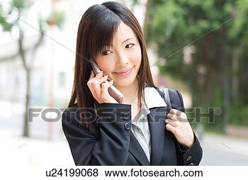 Stock Photo - a mid adult woman 
using mobile phone. 
fotosearch - search 
stock photos, 
pictures, images, 
and photo clipart