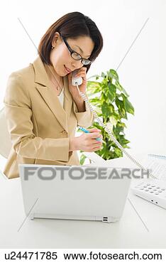 Stock Image - a mid adult woman 
talking over phone. 
fotosearch - search 
stock photos, 
pictures, images, 
and photo clipart