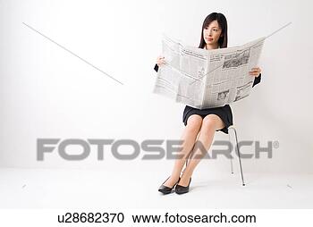 Stock Photography - a mid adult woman 
reading newspaper. 
fotosearch - search 
stock photos, 
pictures, images, 
and photo clipart