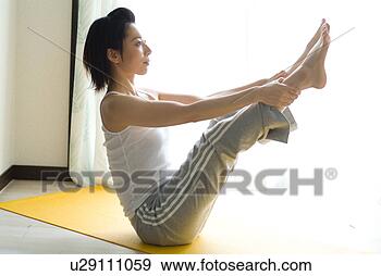Stock Photograph - a mid adult woman 
doing yoga. fotosearch 
- search stock 
photos, pictures, 
images, and photo 
clipart