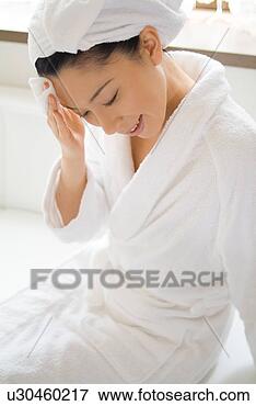 Picture - a mid adult woman 
applying moisturizer. 
fotosearch - search 
stock photos, 
pictures, images, 
and photo clipart