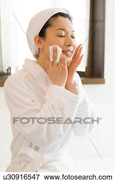 Picture - a mid adult woman 
applying moisturizer. 
fotosearch - search 
stock photos, 
pictures, images, 
and photo clipart