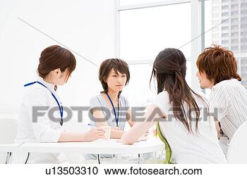Stock Photography - four people meeting 
at table. fotosearch 
- search stock 
photos, pictures, 
images, and photo 
clipart