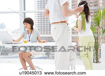 Stock Photo - three young people 
working in office. 
fotosearch - search 
stock photos, 
pictures, images, 
and photo clipart