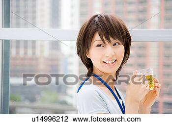 Stock Photo - young woman holding 
a cup of tea. 
fotosearch - search 
stock photos, 
pictures, images, 
and photo clipart