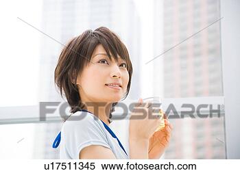 Stock Image - young woman holding 
a cup of tea. 
fotosearch - search 
stock photos, 
pictures, images, 
and photo clipart
