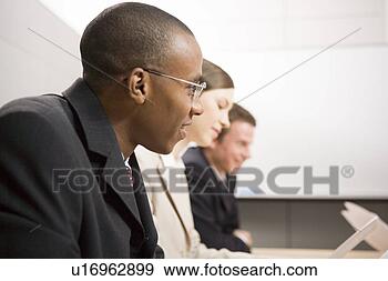 Stock Photograph - business people 
having meeting. 
fotosearch - search 
stock photos, 
pictures, images, 
and photo clipart