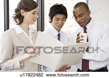 Stock Photo - three business 
people looking 
at file. fotosearch 
- search stock 
photos, pictures, 
images, and photo 
clipart