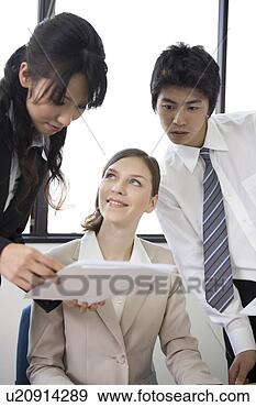Stock Photograph - three business 
people looking 
at documents. 
fotosearch - search 
stock photos, 
pictures, images, 
and photo clipart