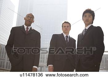 Stock Photo - three businessmen 
standing looking 
at camera. fotosearch 
- search stock 
photos, pictures, 
images, and photo 
clipart