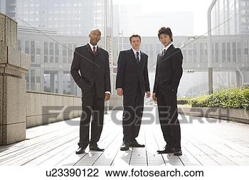 Stock Photo - three businessmen 
standing looking 
at camera. fotosearch 
- search stock 
photos, pictures, 
images, and photo 
clipart