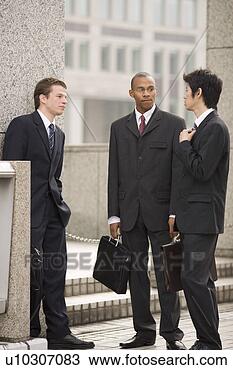 Stock Photo - three businessmen 
talking in front 
of building. fotosearch 
- search stock 
photos, pictures, 
images, and photo 
clipart