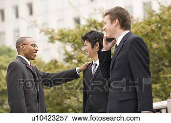 Picture - three businessmen 
talking. fotosearch 
- search stock 
photos, pictures, 
images, and photo 
clipart