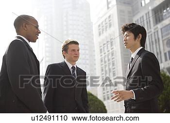 Stock Photography - three businessmen 
talking. fotosearch 
- search stock 
photos, pictures, 
images, and photo 
clipart