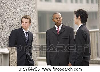 Stock Image - three businessmen 
talking in front 
of building. fotosearch 
- search stock 
photos, pictures, 
images, and photo 
clipart