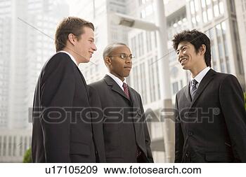 Stock Photograph - three businessmen 
talking. fotosearch 
- search stock 
photos, pictures, 
images, and photo 
clipart