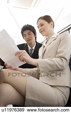 Stock Photograph - two business people 
looking at document. 
fotosearch - search 
stock photos, 
pictures, images, 
and photo clipart