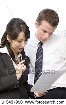 Stock Photography - two business people 
looking at document. 
fotosearch - search 
stock photos, 
pictures, images, 
and photo clipart