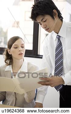Stock Photo - two business people 
looking at file. 
fotosearch - search 
stock photos, 
pictures, images, 
and photo clipart