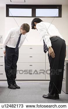 Stock Photo - two businessmen 
bowing to each 
other. fotosearch 
- search stock 
photos, pictures, 
images, and photo 
clipart