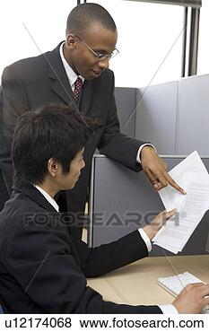 Stock Photo - two businessmen 
looking at documents. 
fotosearch - search 
stock photos, 
pictures, images, 
and photo clipart