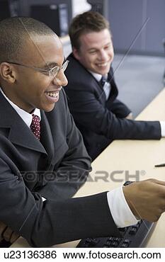 Stock Photo - two businessmen 
smiling. fotosearch 
- search stock 
photos, pictures, 
images, and photo 
clipart