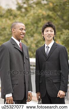 Picture - two businessmen 
standing. fotosearch 
- search stock 
photos, pictures, 
images, and photo 
clipart