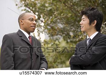 Picture - two businessmen 
talking. fotosearch 
- search stock 
photos, pictures, 
images, and photo 
clipart