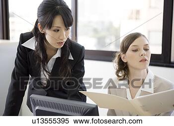 Stock Image - two businesswomen 
looking at file. 
fotosearch - search 
stock photos, 
pictures, images, 
and photo clipart