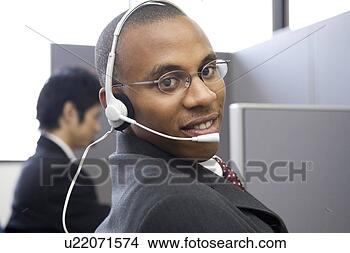Stock Photo - young man working 
in call center. 
fotosearch - search 
stock photos, 
pictures, images, 
and photo clipart