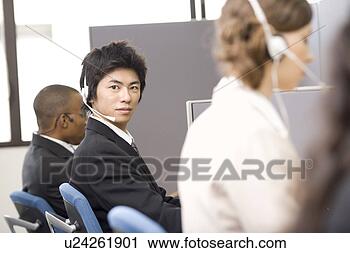 Stock Photography - young man working 
in call center. 
fotosearch - search 
stock photos, 
pictures, images, 
and photo clipart
