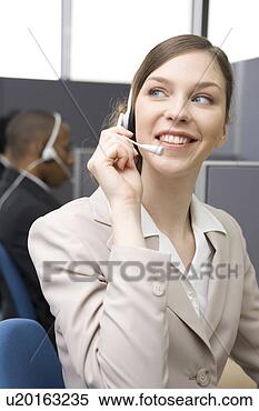 Stock Image - young woman working 
in call center. 
fotosearch - search 
stock photos, 
pictures, images, 
and photo clipart