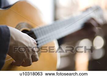 Stock Photo - young man playing 
acoustic guitar. 
fotosearch - search 
stock photos, 
pictures, images, 
and photo clipart