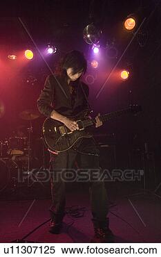 Stock Image - young man playing 
electric guitar 
on stage. fotosearch 
- search stock 
photos, pictures, 
images, and photo 
clipart