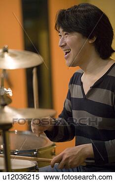 Stock Image - young man playing 
drums. fotosearch 
- search stock 
photos, pictures, 
images, and photo 
clipart