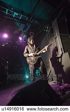 Stock Photo - young man playing 
electric guitar 
on stage. fotosearch 
- search stock 
photos, pictures, 
images, and photo 
clipart