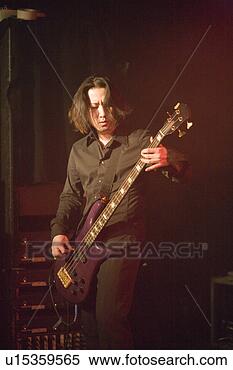 Stock Image - young man playing 
bass guitar on 
stage. fotosearch 
- search stock 
photos, pictures, 
images, and photo 
clipart