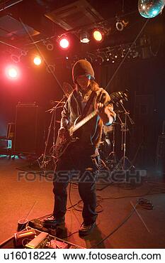 Stock Photo - young man playing 
electric guitar 
on stage. fotosearch 
- search stock 
photos, pictures, 
images, and photo 
clipart