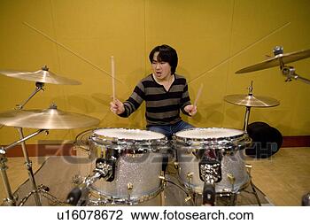 Stock Photo - young man playing 
drums. fotosearch 
- search stock 
photos, pictures, 
images, and photo 
clipart