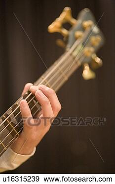 Stock Photograph - young man playing 
bass guitar. fotosearch 
- search stock 
photos, pictures, 
images, and photo 
clipart