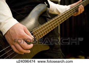 Stock Photo - young man playing 
bass guitar. fotosearch 
- search stock 
photos, pictures, 
images, and photo 
clipart