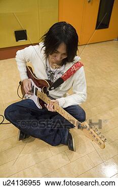 Stock Image - young man playing 
electric guitar. 
fotosearch - search 
stock photos, 
pictures, images, 
and photo clipart
