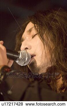 Stock Photo - young man singing 
on stage. fotosearch 
- search stock 
photos, pictures, 
images, and photo 
clipart